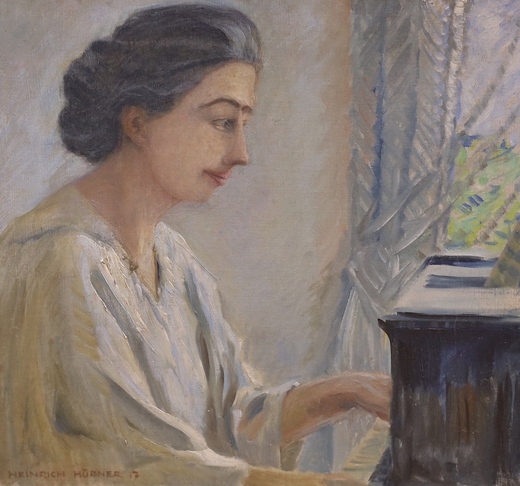 Heinrich Hübner (German, 1869-1945), oil on canvas, Lady playing the piano, signed and dated '17, 42 x 46cm